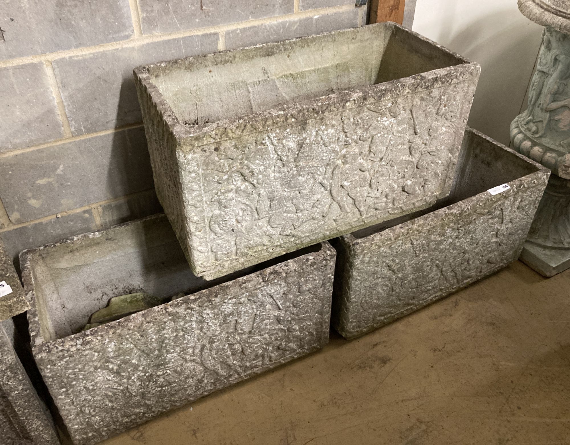 A set of three reconstituted stone rectangular garden planters with claw feet, width 77cm, depth 39cm, height 44cm